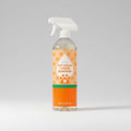 Pet stain and odor remover bottle with a towel and cucumber on a tiled background