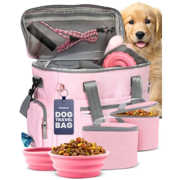 Pink dog travel bag with pet accessories on a white background