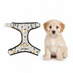 A dog harness with a white background and a colorful retro pattern of yellow guitars, vinyl records, and music notes, 