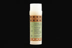 Bottle of natural paw balm for pets with a label